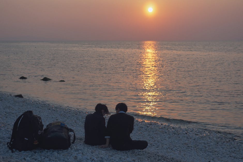 backpackers enjoying sunset beach