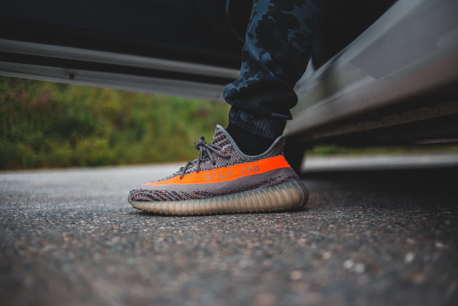 Close-up of stylish sneakers and cargo pants on a person walking in an urban setting