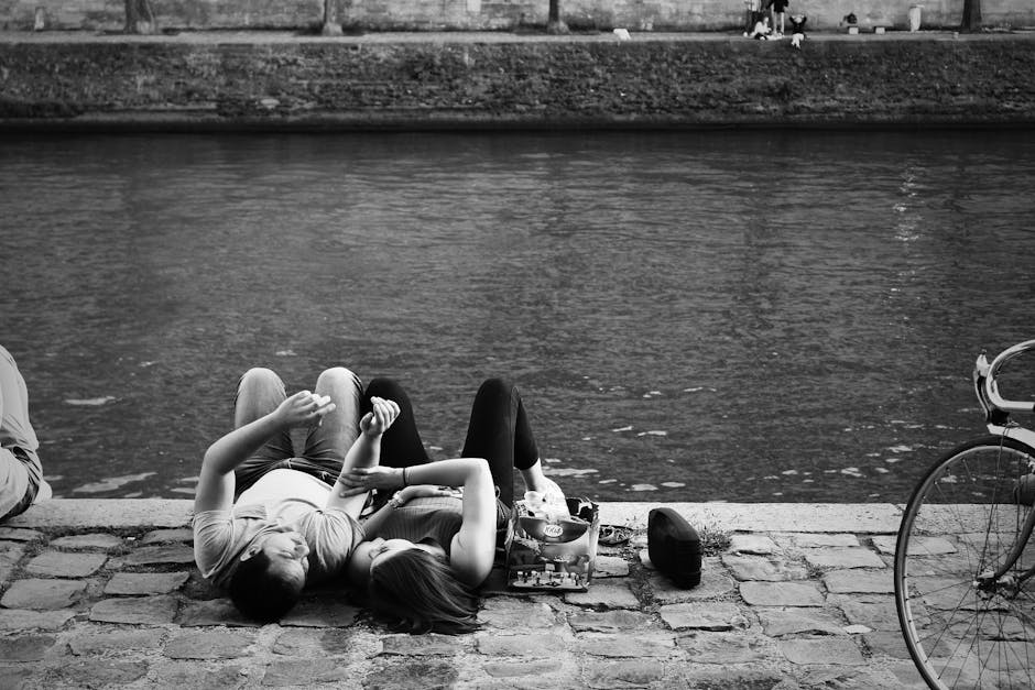 couple picnicking by river in france