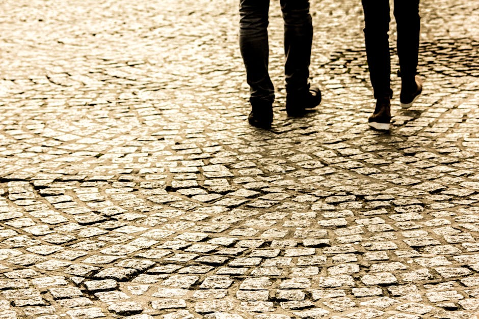 couple walking on cobblestone street
