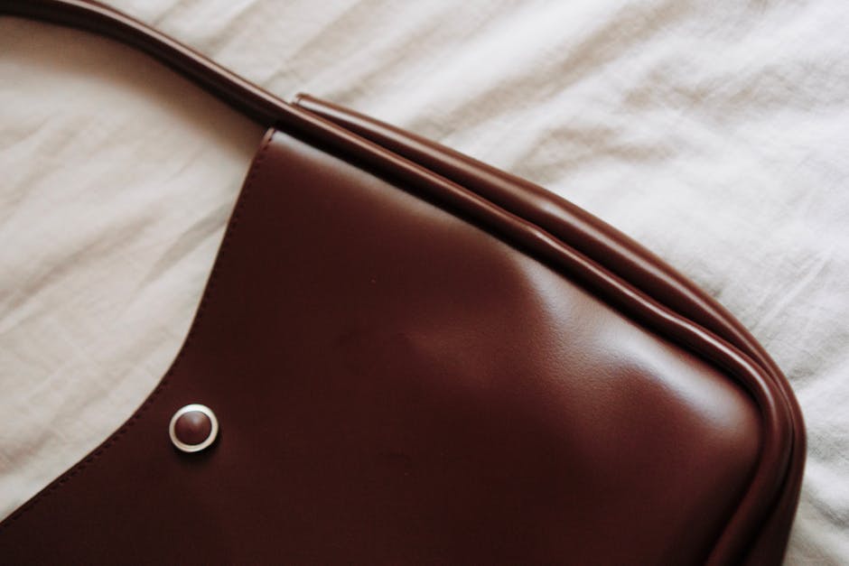 details of a classic leather handbag and watch