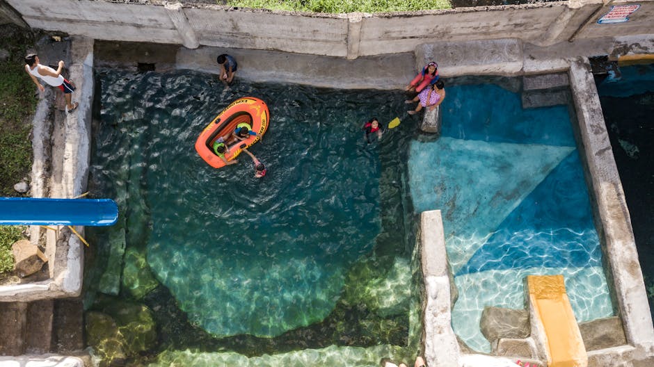 kids swimming in natural pool in forest