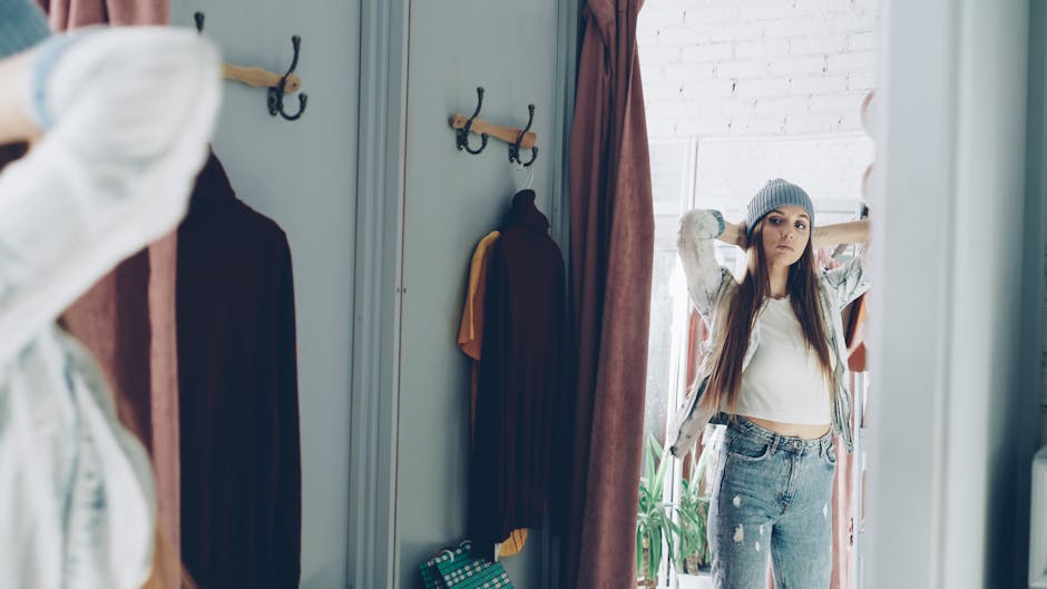 man trying clothes in store mirror