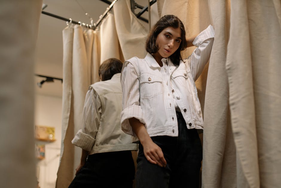 man trying on jacket in changing room