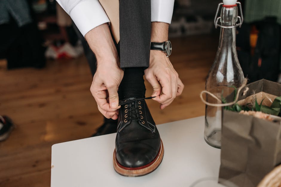 man tying shoelaces on classic leather shoes