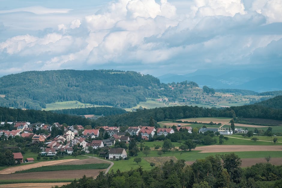 Panoramic view of green rolling hills and small village