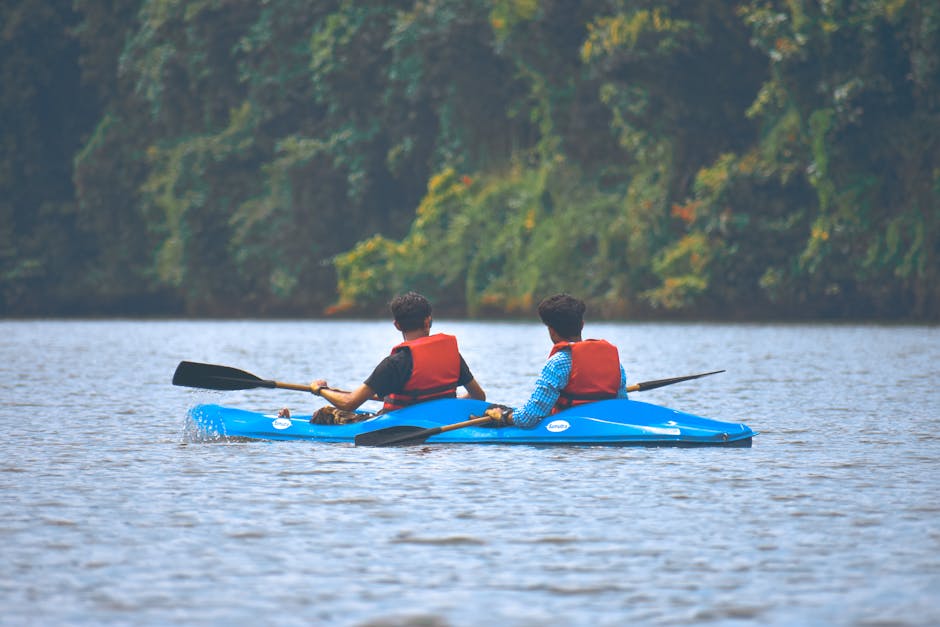 People kayaking on calm river in nature