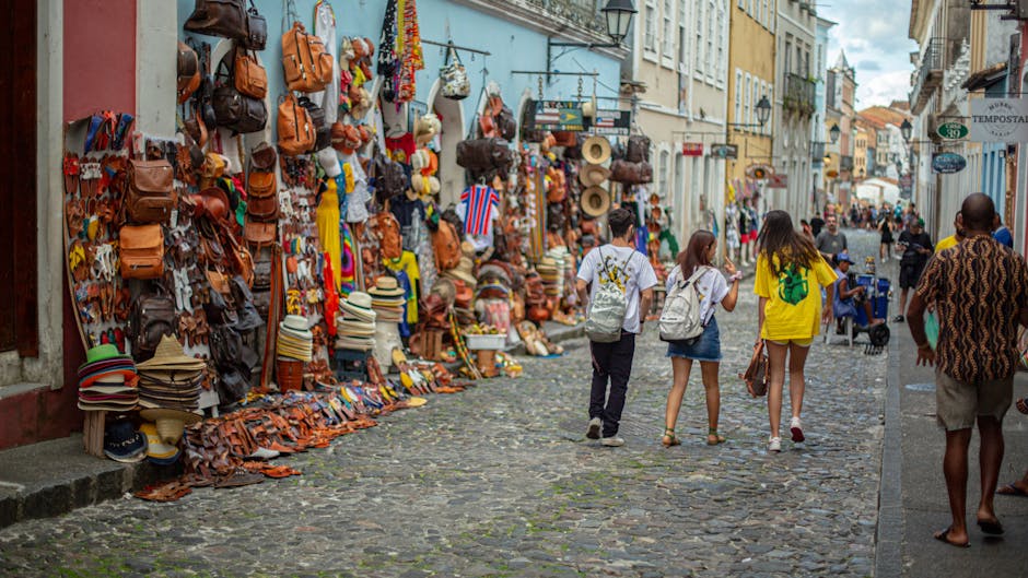 People walking in a vibrant street market in Brazil with colorful outfits