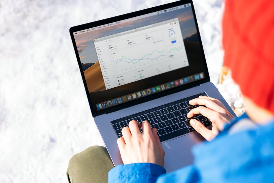 professional using laptop with analytics dashboard