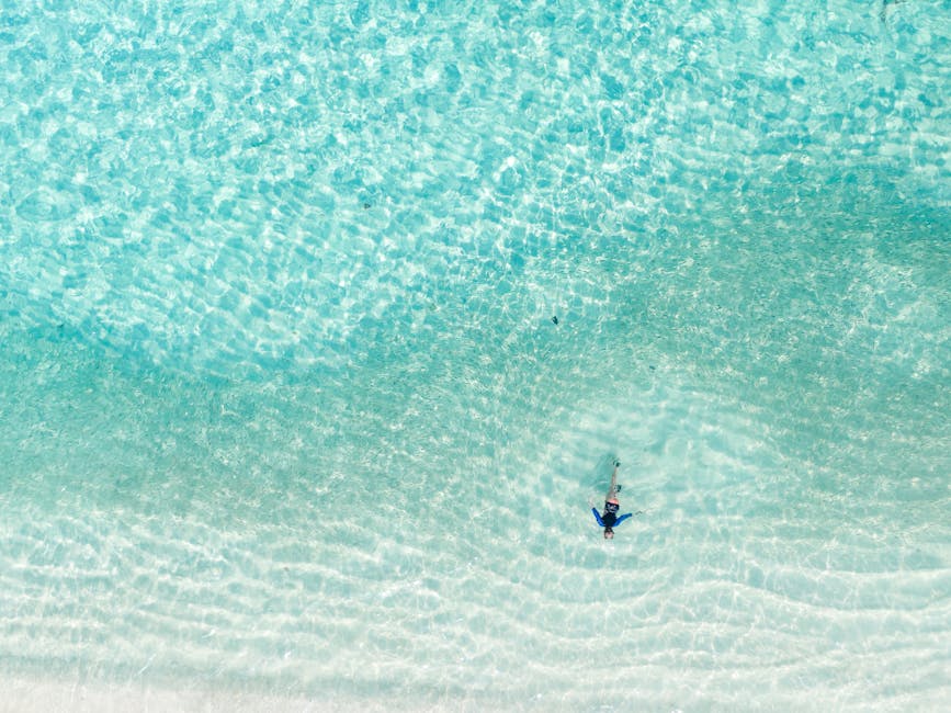 solo traveler relaxing on a beach with hammocks in water