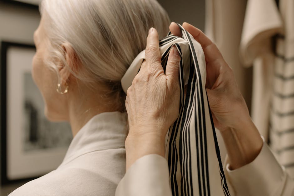 woman adjusting elegant silk scarf around neck