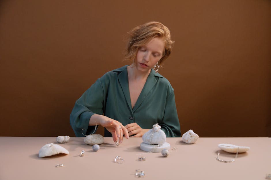 woman arranging minimalist jewelry