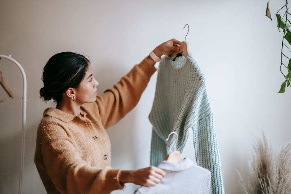 woman comparing two outfits in a bright room
