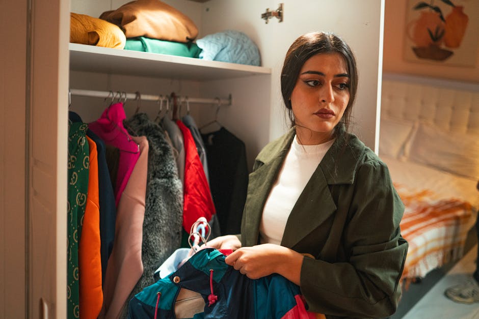 woman organizing clothes in closet