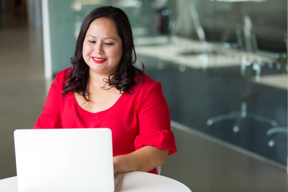 woman smiling working on computer in modern office