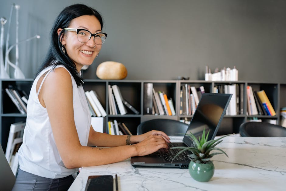 Woman using laptop in modern office