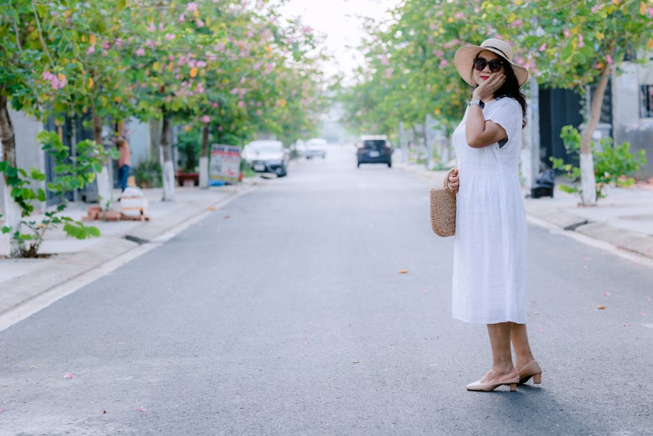 woman wearing linen dress straw bag summer