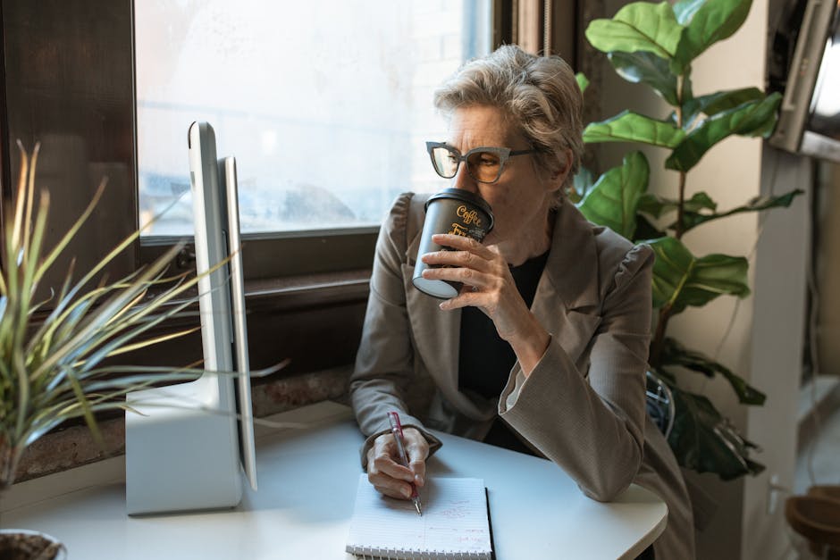 woman working on computer with coffee