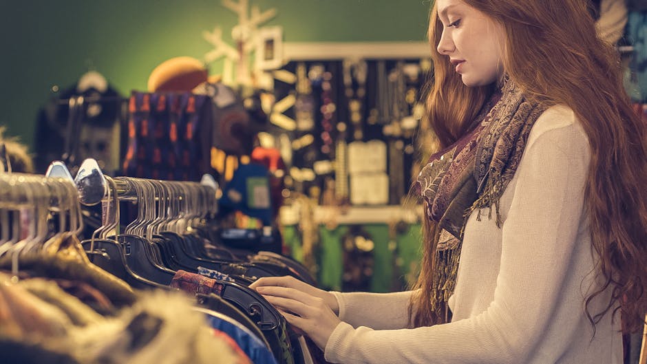 Young woman browsing clothes in a vintage shop