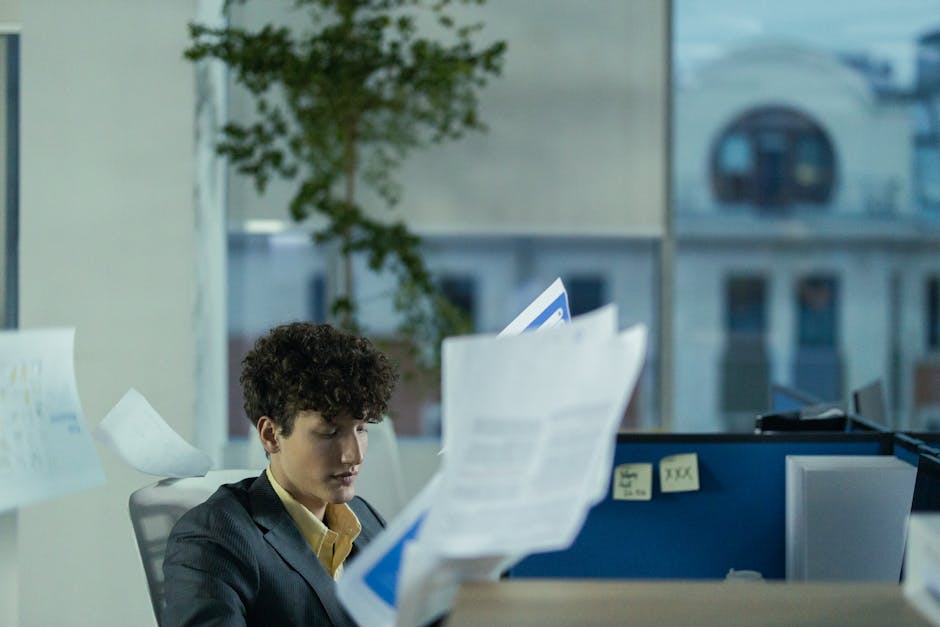 busy professional juggling multiple tasks in modern office