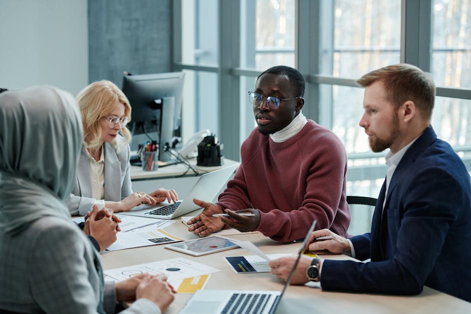 Diverse group collaborating on AI project in office