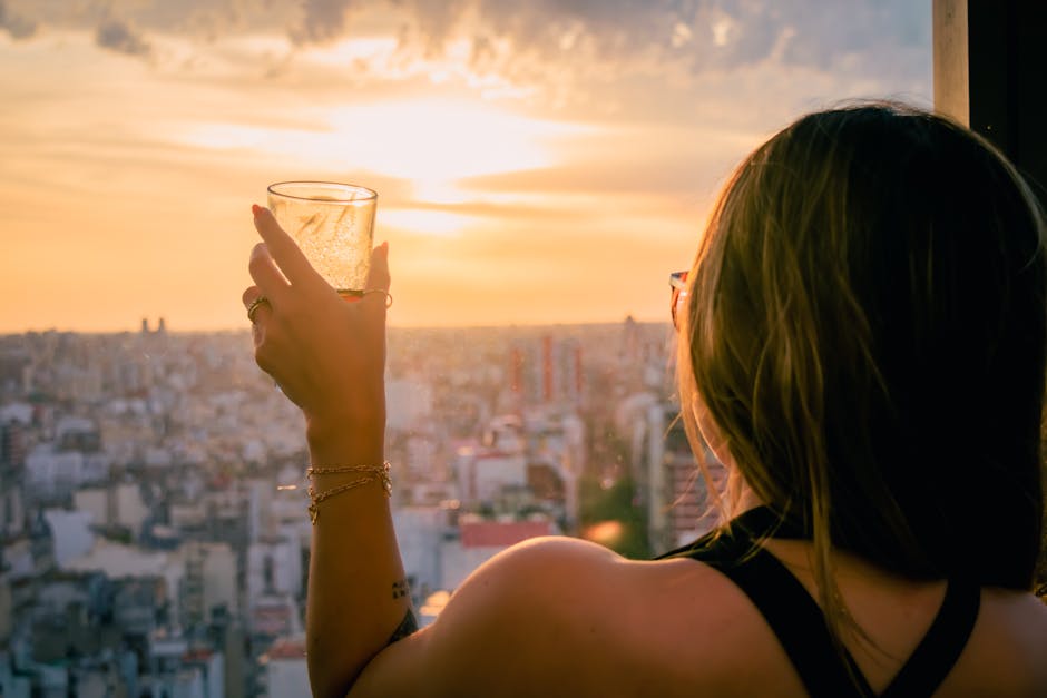 elegant woman enjoying coffee on a balcony overlooking a city