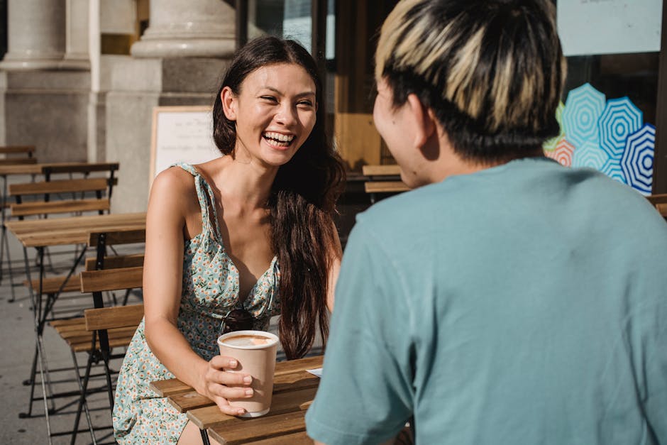 friends laughing enjoying coffee outdoors