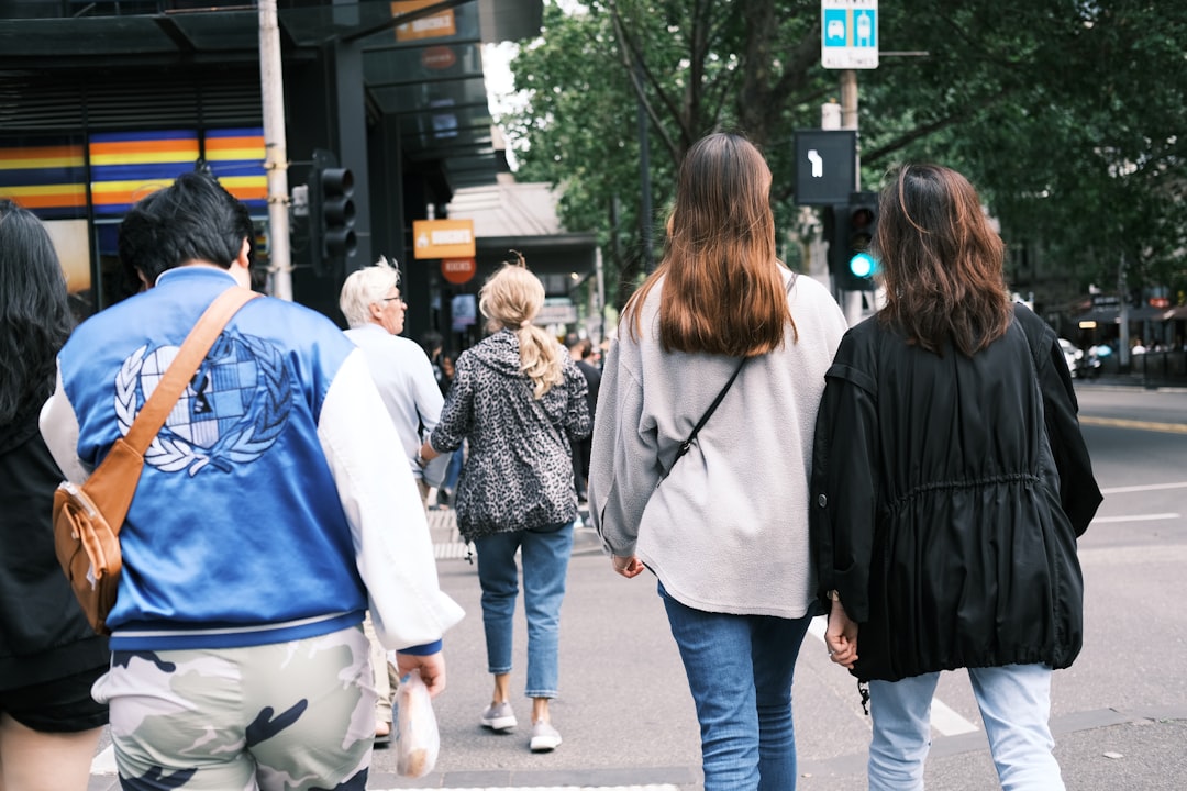 group of friends wearing stylish denim outfits walking city
