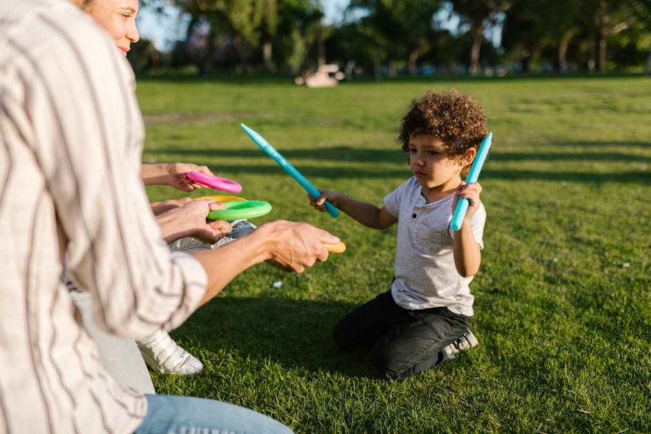 Kids playing outdoors with parents in park
