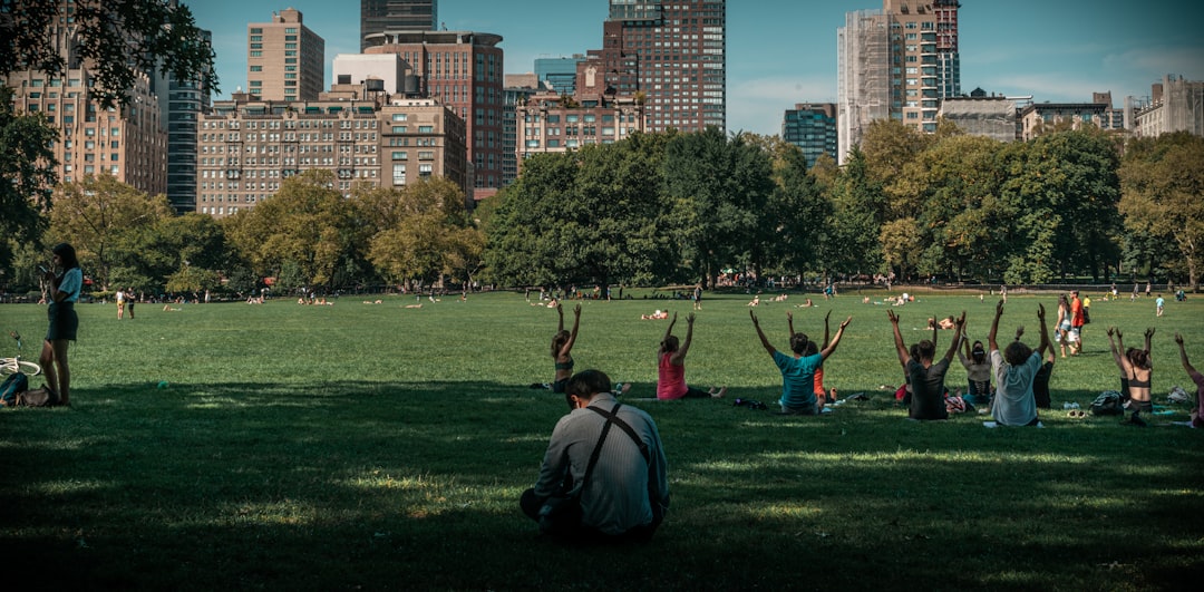 people doing yoga in park