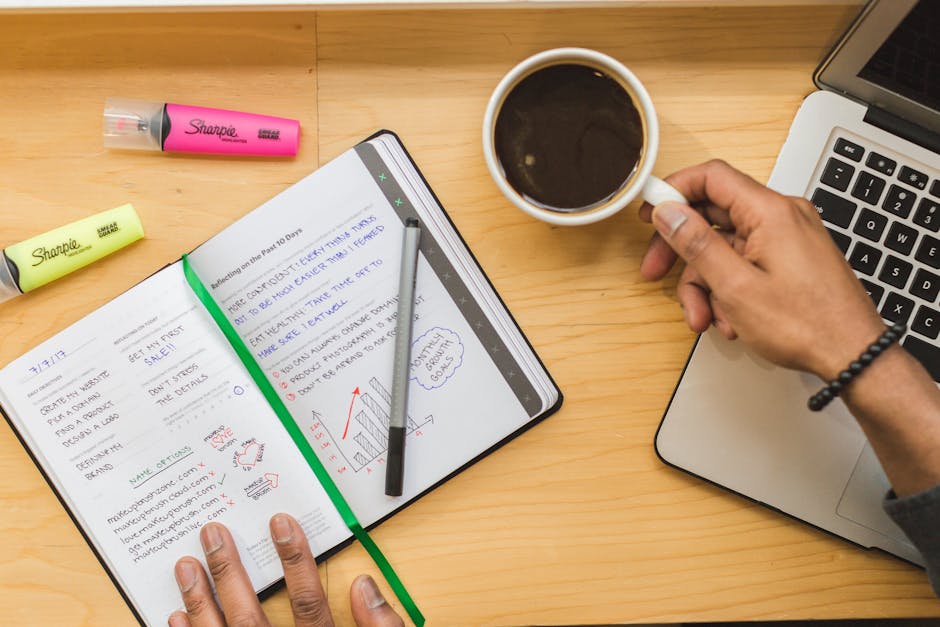 person planning day with notebook coffee