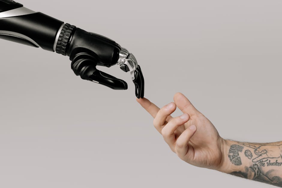 robot hand interacting with human hand on tablet