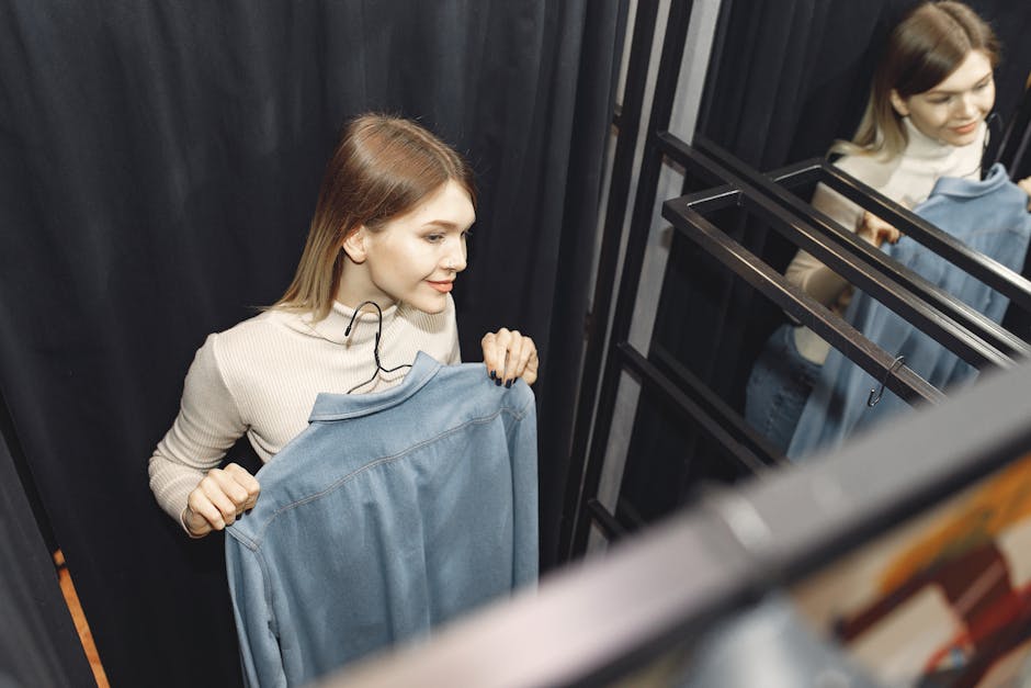 Stylish woman trying on embroidered dress in boutique