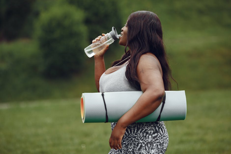 woman drinking water and doing yoga