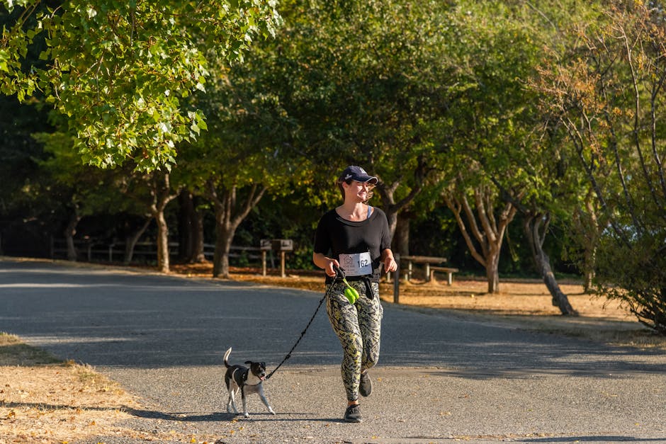 woman jogging with dog in park