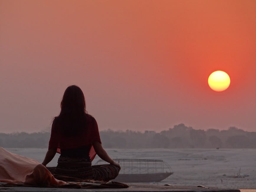 woman meditating at sunrise