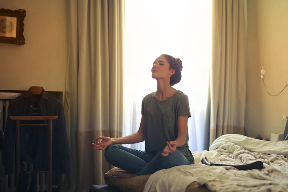 woman meditating by window