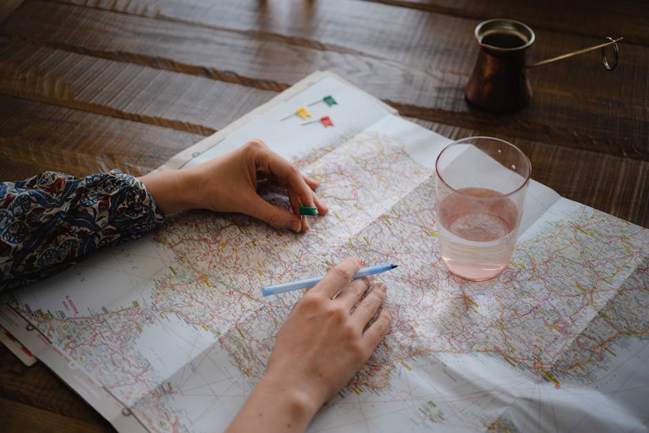 woman planning trip on map