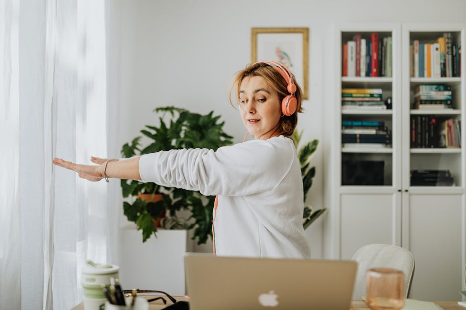 young person stretching at home desk