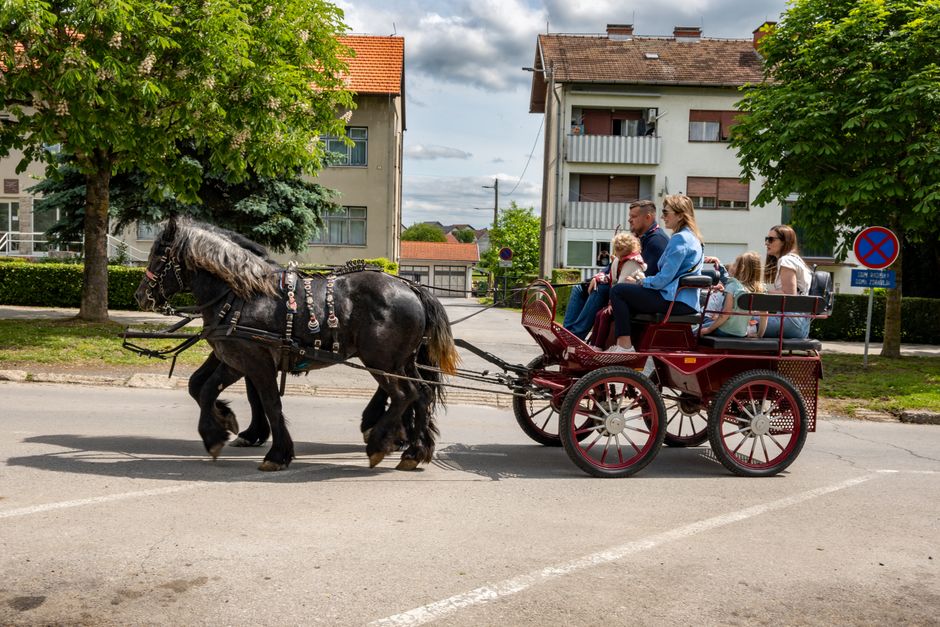 Сям'я з бацькамі і дзецьмі едзе ў трамваі па вузкіх вуліцах старога горада, разглядаючы мясцовыя славутасці.