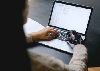 Жінка працює за комп'ютером, використовуючи ШІ для написання електронного листа, на екрані видно інтерфейс чат-бота.