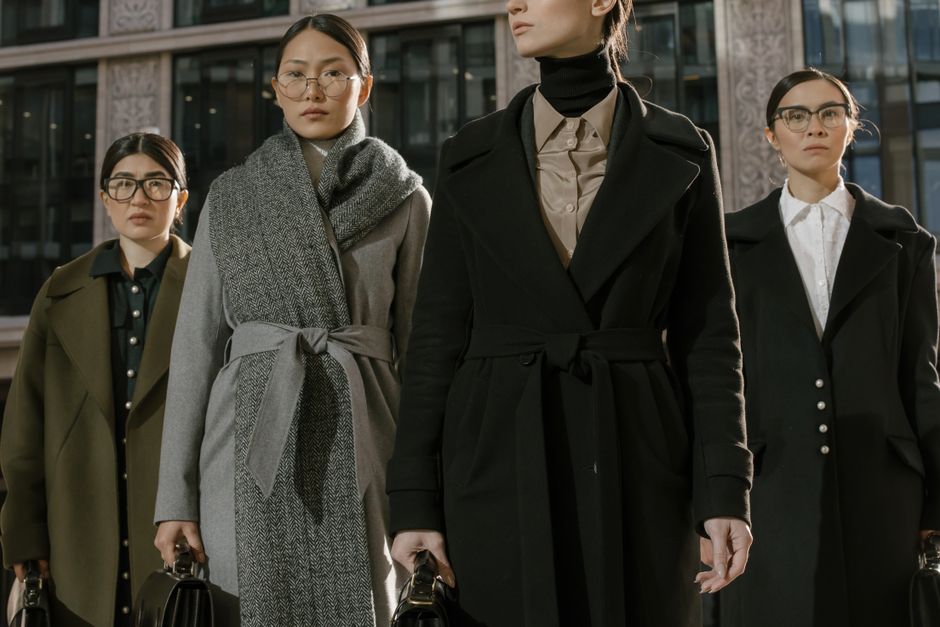 Una donna elegante che cammina per le strade di una città italiana, indossando un outfit classico e senza tempo