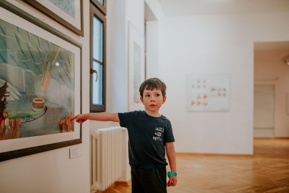 Genitori che cercano di intrattenere i bambini stanchi in una sala espositiva